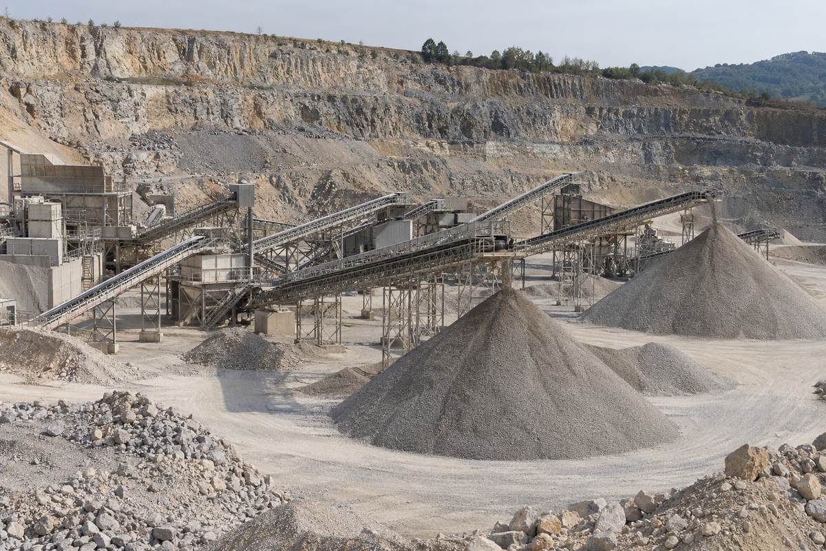 Aggregate quarry with a crusher, conveyors and stone stockpiles